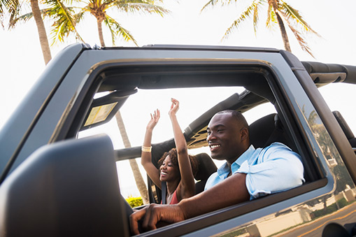 Couple driving in Jeep.