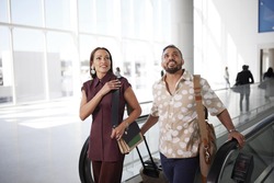Man and woman traveling through airport